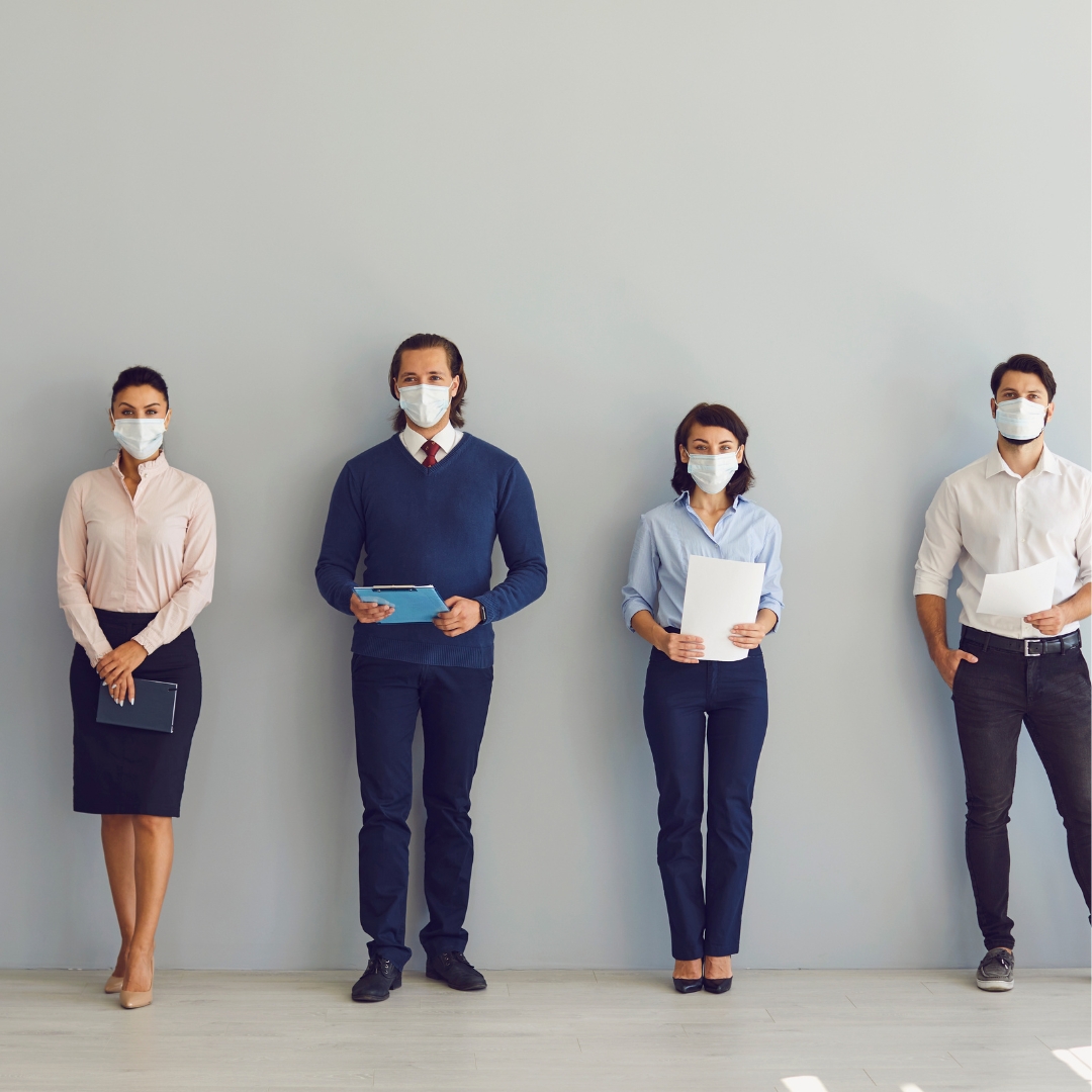 4 people standing with masks